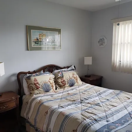 a bedroom with a bed and a painting on the wall