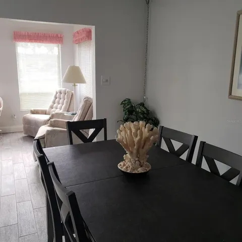 a dining room with furniture and wooden floor