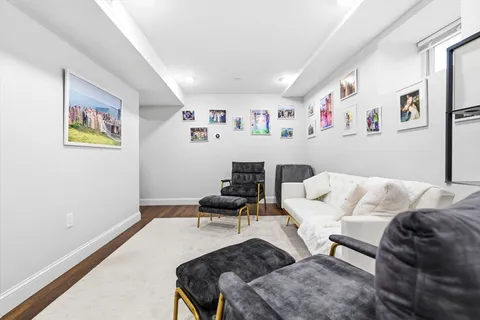 a living room with furniture and wall paintings