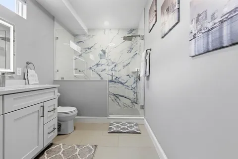 a bathroom with a sink toilet and shower