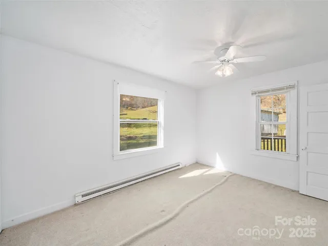 a view of a house with a yard and deck