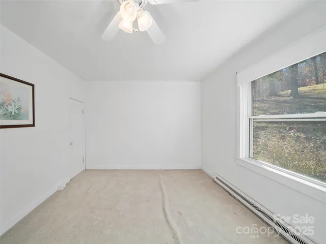 a view of a house with a yard and wooden fence