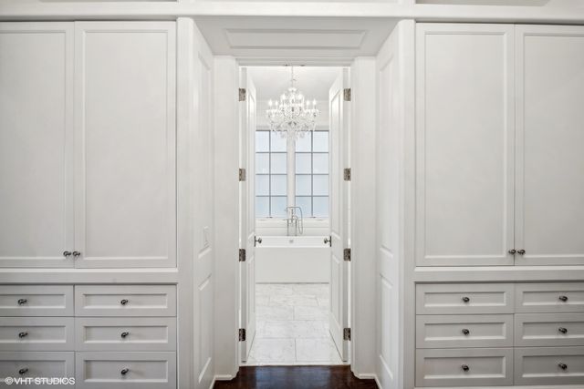 a spacious bathroom with a granite countertop sink a mirror a vanity and a bathtub