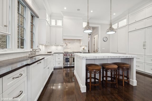 a dining room with stainless steel appliances kitchen island granite countertop a dining table chairs and view living room
