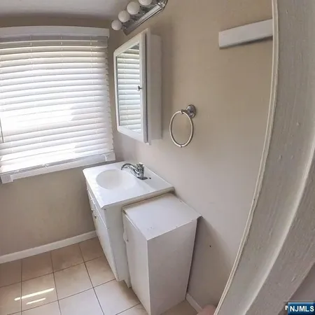 a bathroom with a sink a toilet and a window