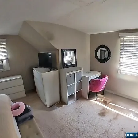 a living room with furniture and a chair