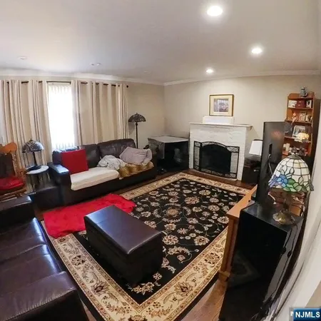 a living room with furniture rug and a fireplace
