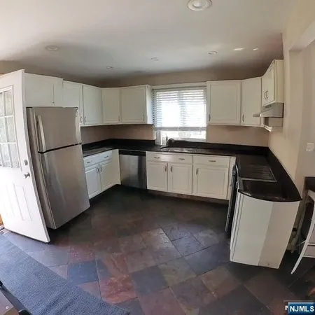 a kitchen with a refrigerator a sink and a stove