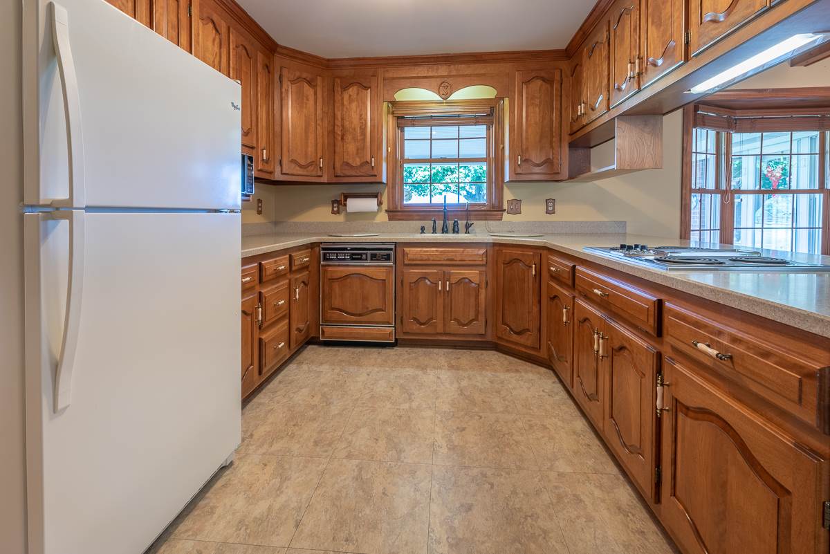158 Battlefield Road Waynesboro, VA 22980 - Photo 34 of 50 a kitchen with stainless steel appliances granite countertop a refrigerator sink and wooden cabinets