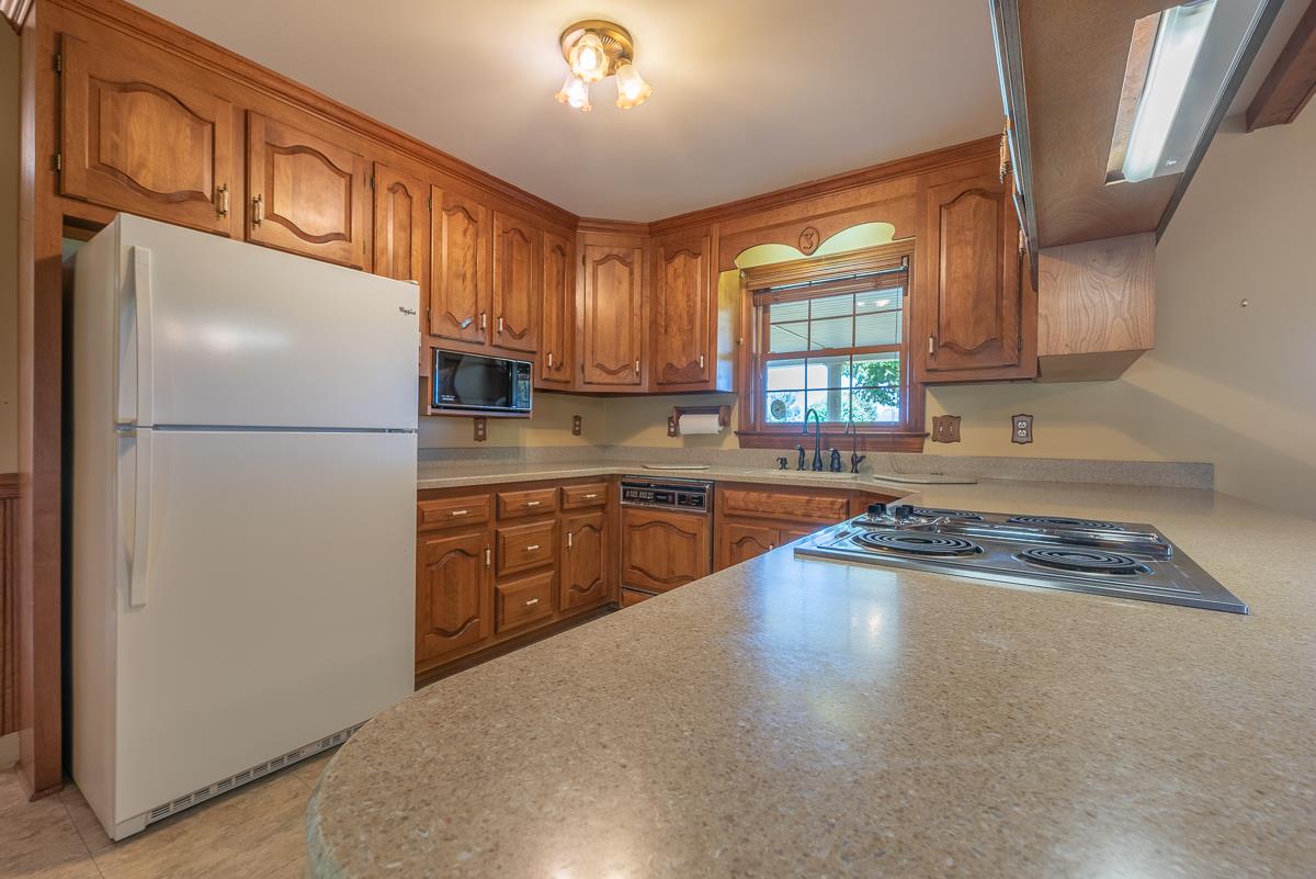 158 Battlefield Road Waynesboro, VA 22980 - Photo 35 of 50 a kitchen with a refrigerator a stove a sink dishwasher and cabinets with wooden floor