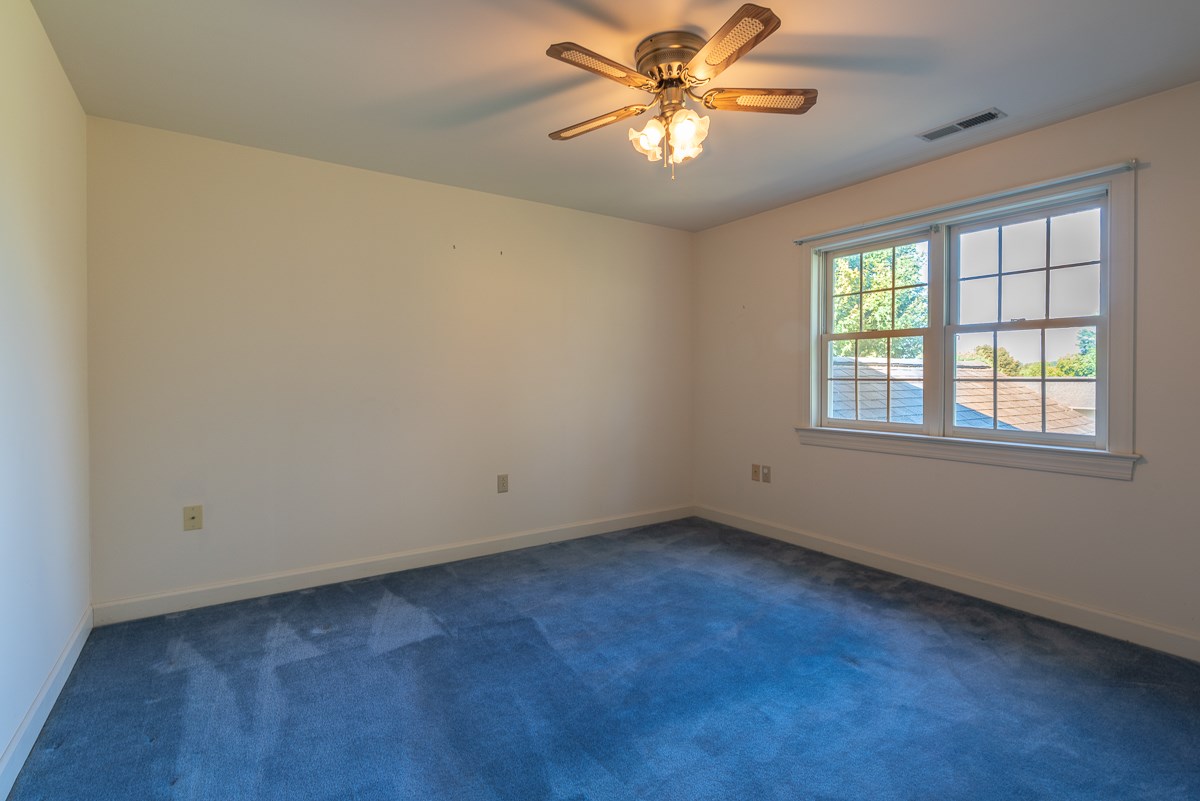 158 Battlefield Road Waynesboro, VA 22980 - Photo 47 of 50 an empty room with windows and chandelier fan