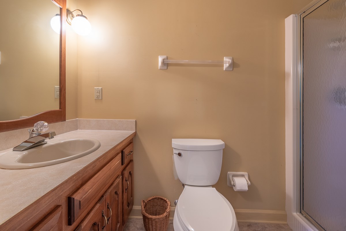 158 Battlefield Road Waynesboro, VA 22980 - Photo 49 of 50 a bathroom with a toilet a sink and mirror