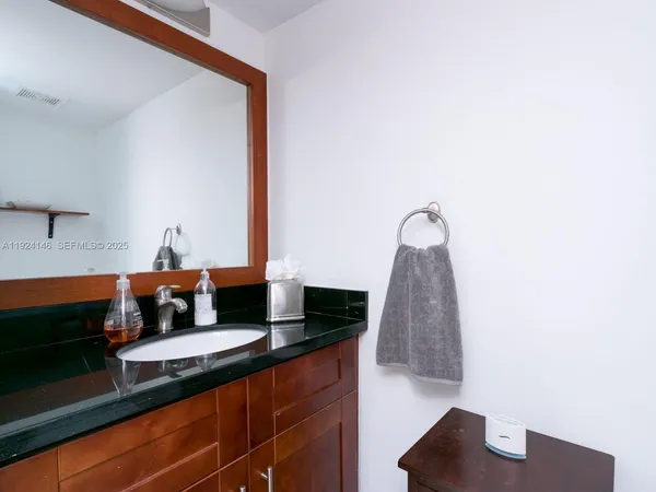a front view of a house with a yard and potted plants