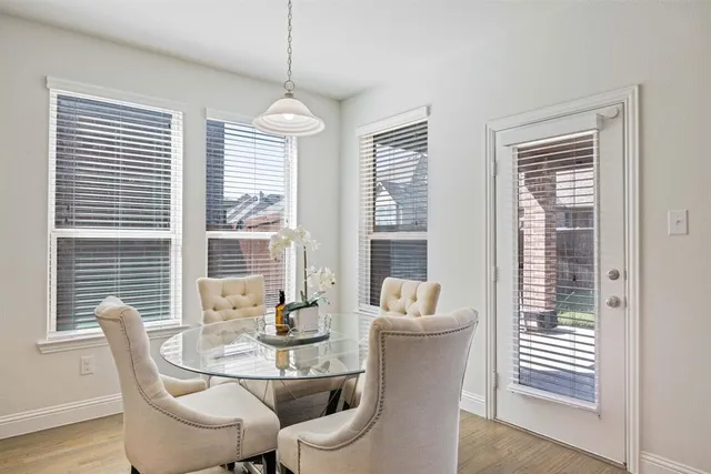 a dining room with furniture and windows