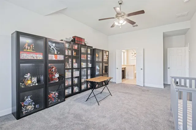 a living room with furniture a ceiling fan and a window