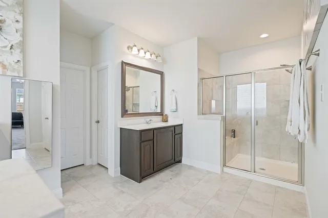 a bathroom with a shower and a sink