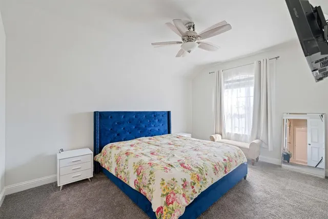 a bed sitting in a bedroom next to a window