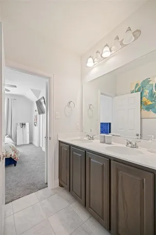 a spacious bathroom with a double vanity sink and a mirror