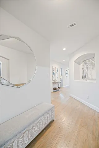 a spacious bedroom with a bed and a painting on the wall