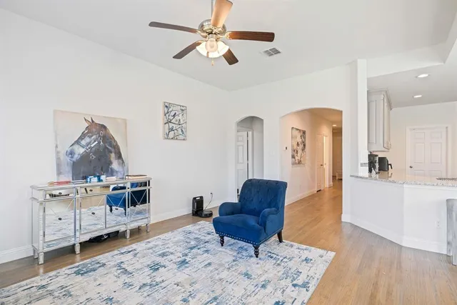 a living room with furniture and a dresser