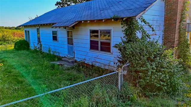 a view of swimming pool with outdoor seating and trees in the background