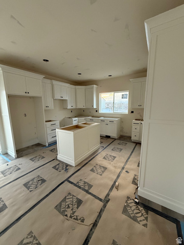 352 East Mistilake Lane, Unit 20 Draper, UT 84020 - Photo 2 of 2 Kitchen featuring white cabinetry and a center island