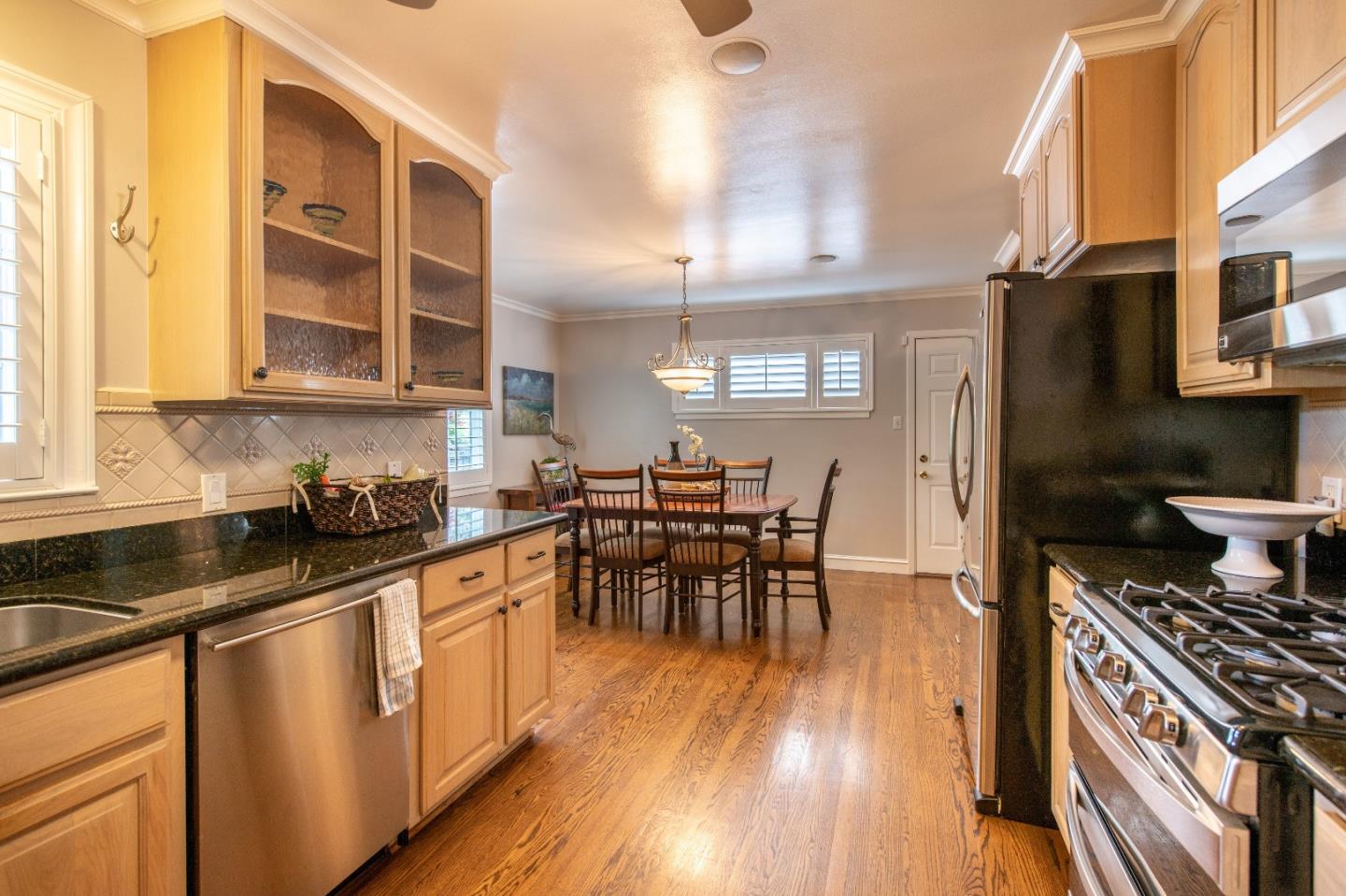 500 Yale Drive San Mateo, CA 94402 - Photo 11 of 35 a kitchen with stainless steel appliances a stove a sink a kitchen island with wooden cabinets and floor
