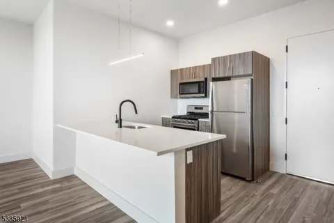 a kitchen with a refrigerator and a sink