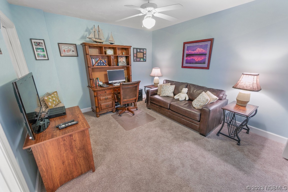 4575 South Atlantic Avenue, Unit 6307 Ponce Inlet, FL 32127 - Photo 24 of 36 a living room with furniture and book shelfs