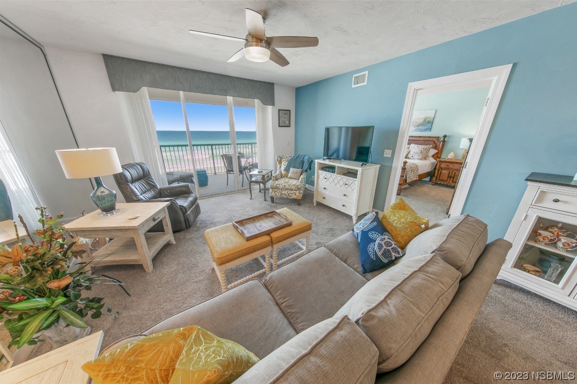 4575 South Atlantic Avenue, Unit 6307 Ponce Inlet, FL 32127 - Photo 3 of 36 a living room with furniture and a large window