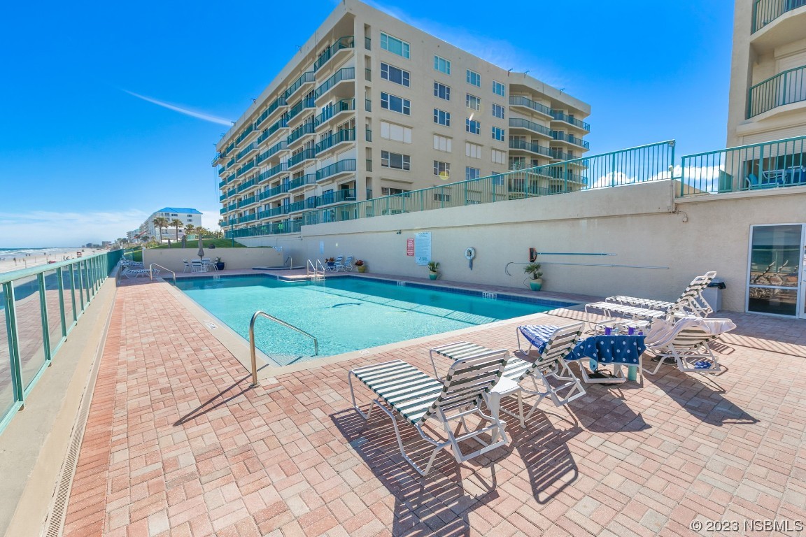 4575 South Atlantic Avenue, Unit 6307 Ponce Inlet, FL 32127 - Photo 33 of 36 a view of a swimming pool with a lounge chairs