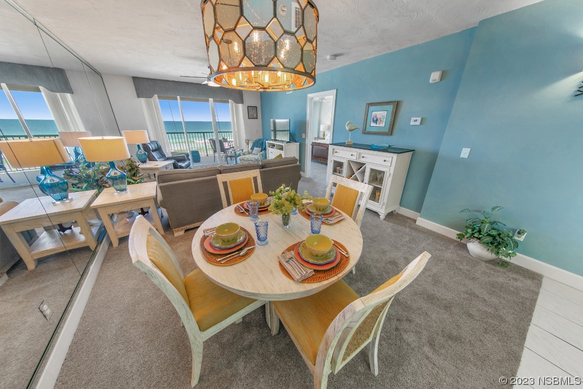 4575 South Atlantic Avenue, Unit 6307 Ponce Inlet, FL 32127 - Photo 6 of 36 a view of a dining room with furniture window and wooden floor