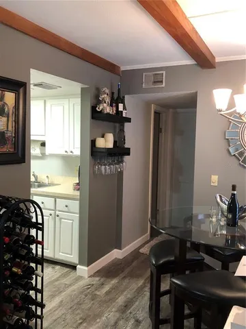 a kitchen with a sink refrigerator and cabinets