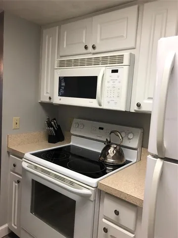 a stove top oven sitting inside of a kitchen