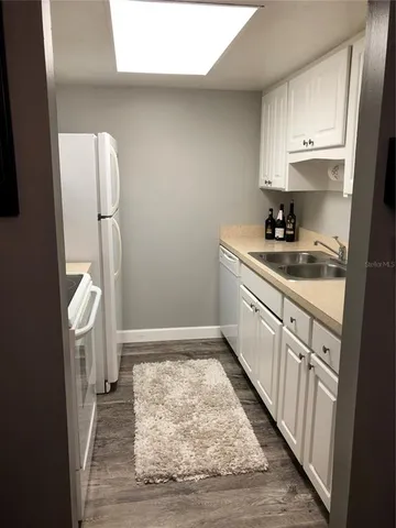 a kitchen with a sink stove and refrigerator