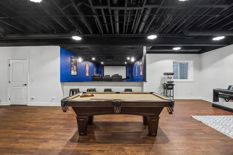 a living room with patio furniture and a floor to ceiling window