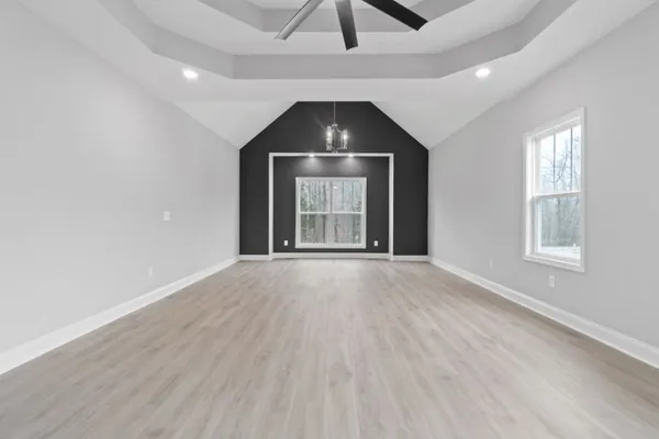 an empty room with windows and closet