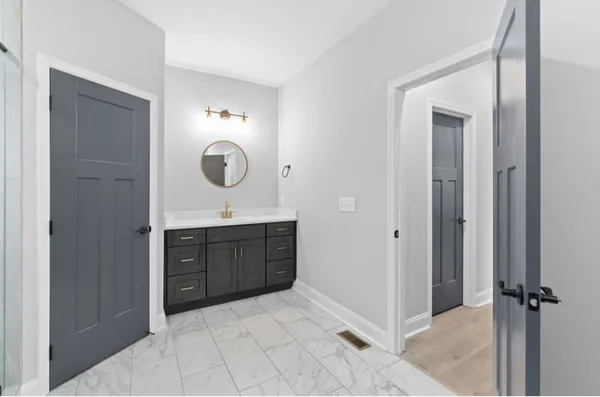 a spacious bathroom with a sink and a mirror