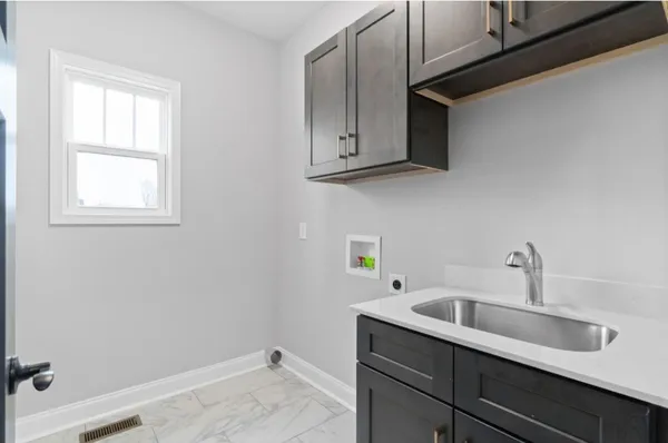 a bathroom with a sink and cabinets