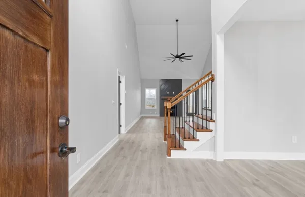 a view of entryway and hall with wooden floor