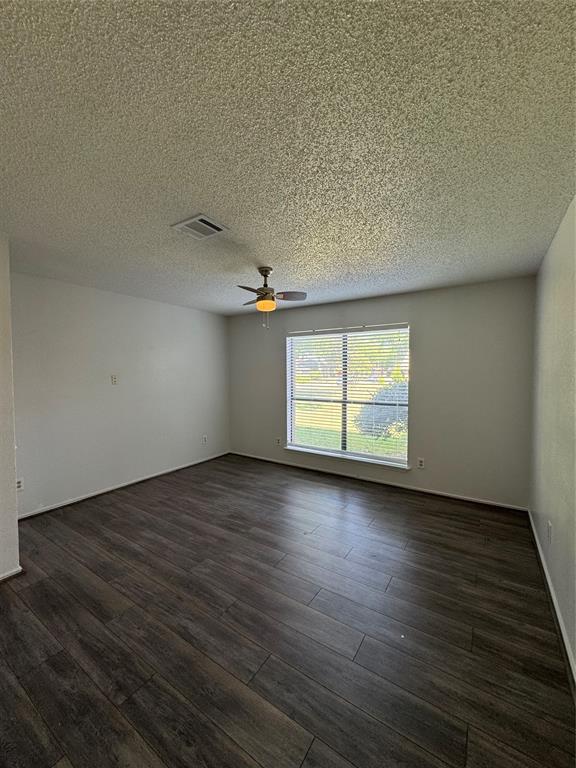5824 Emrose Terrace Dallas, TX 75227 - Photo 11 of 11 an empty room with wooden floor and windows