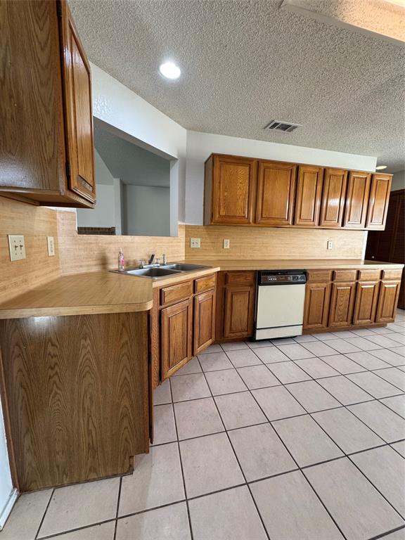 5824 Emrose Terrace Dallas, TX 75227 - Photo 4 of 11 a kitchen with stainless steel appliances granite countertop a sink and cabinets