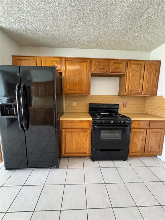 5824 Emrose Terrace Dallas, TX 75227 - Photo 5 of 11 a kitchen with a refrigerator and a stove