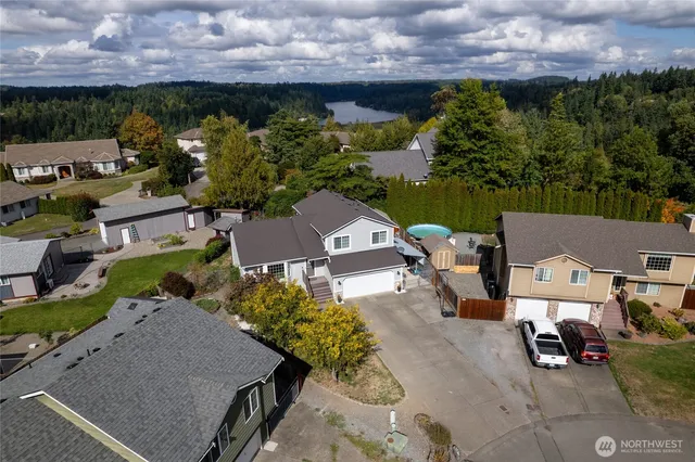 an aerial view of a house with a yard basket ball court and outdoor seating