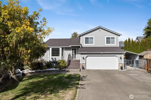 a front view of a house with a garden and plants