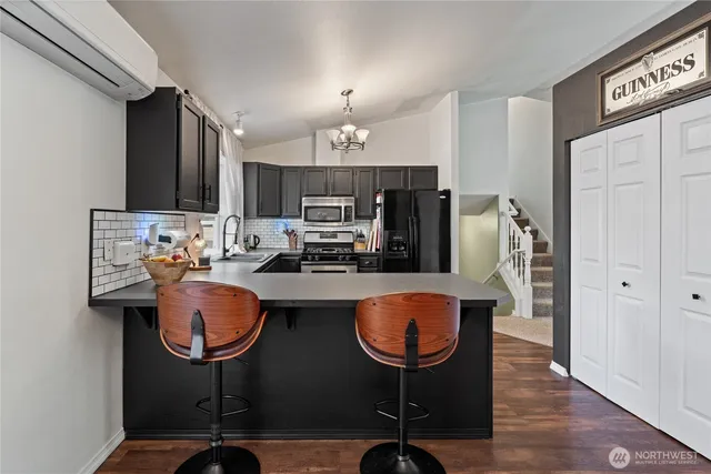 a kitchen with sink refrigerator and cabinets
