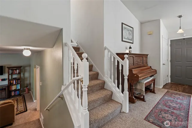 a view of entryway and hall with wooden floor