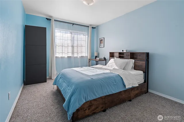 a bedroom with a bed and window