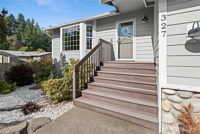 a view of a house with a small yard and wooden floor and fence