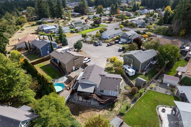 an aerial view of a house with a swimming pool yard and outdoor seating